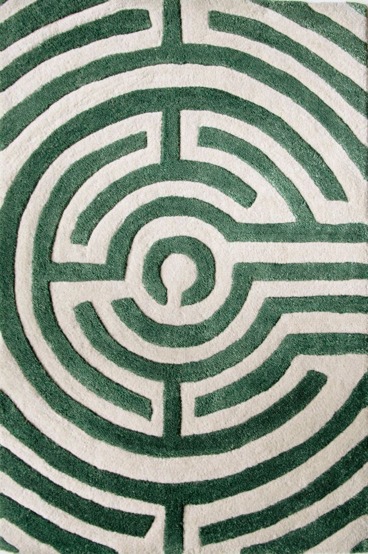 a green and white rug with a spiral design on it