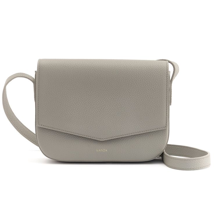 This pebbled leather Mini crossbody bag is designed with a front flap closure and an internal pocket featuring the signature long zipper puller that is a pleasure to use.  It also has a card holder and a key clip.  It is the perfect size to carry your essentials.  There’s an external slip pocket in the back of the bag for easy access.  The bag is finished with gold tone hardware and an adjustable shoulder strap. It is lined with a beautiful beige suede microfibre. Comes with its own dust bag. Keep your bag inside dust bag when not in use. To clean, simply use an unscented baby wipe and use circular motions to wipe off dirt. Classic Textured Leather Crossbody Flap Bag, Everyday Textured Leather Flap Bag, Textured Leather Travel Flap Bag, Modern Textured Leather Saddle Bag For Travel, Modern Textured Leather Flap Bag, Modern Textured Leather Crossbody Flap Bag, Baby Wipe, Bag Inside, Circular Motion