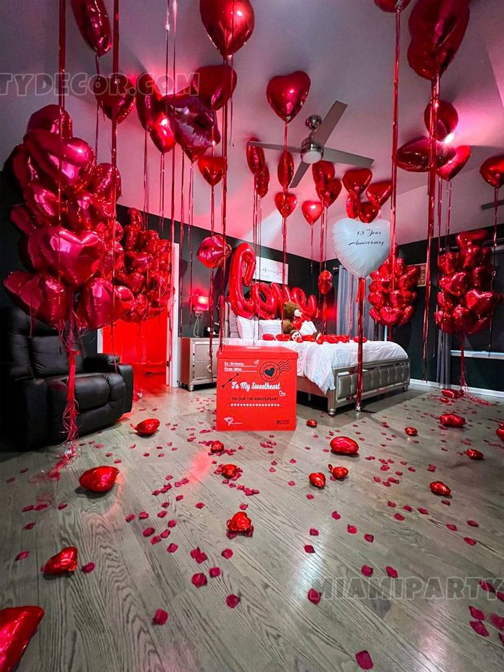 the room is decorated with red balloons and streamers for valentine's day celebrations