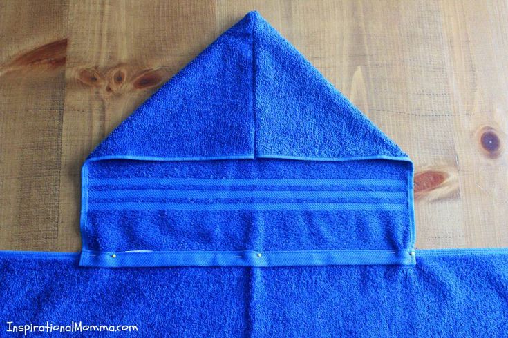 a blue towel folded on top of a wooden table