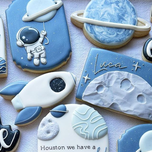 some cookies that have been decorated to look like astronauts