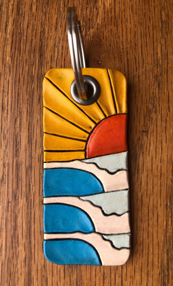 a wooden table with a keychain on it that has an image of the sun