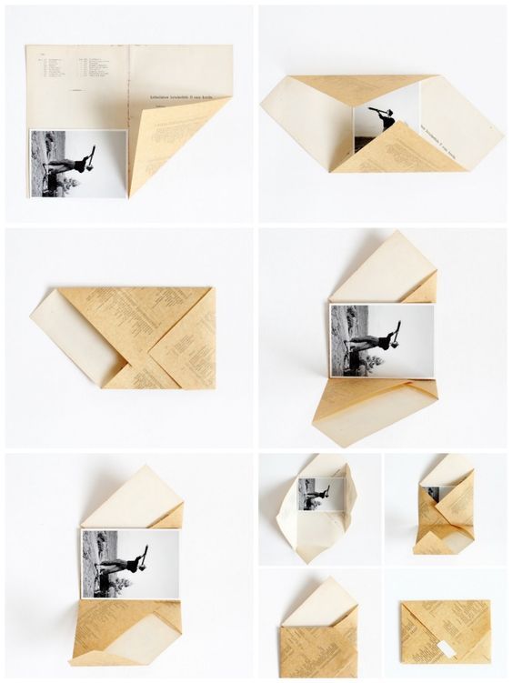 the folded paper is being used to make an origami boat with pictures on it