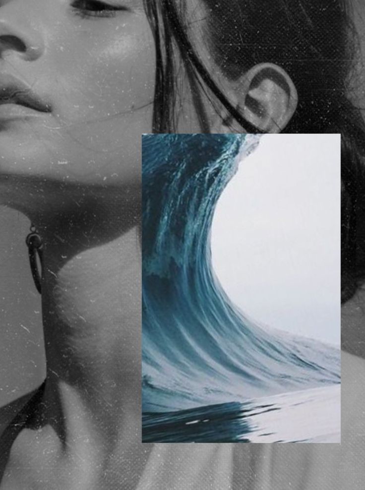 a woman with her eyes closed standing in front of an ocean wave