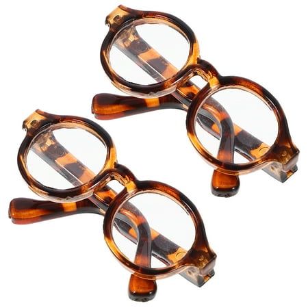 two pairs of reading glasses sitting on top of each other