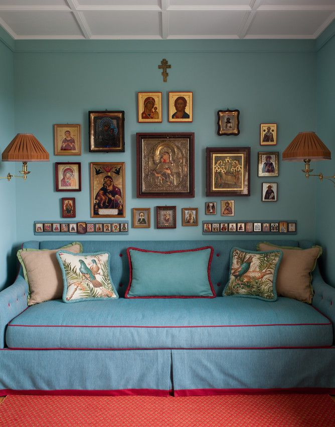 a blue couch with many pictures on the wall