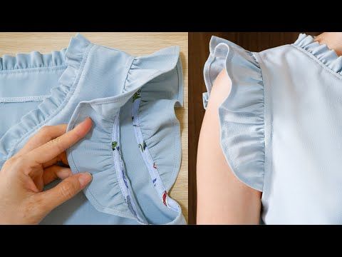 the back of a blue dress being sewn on by a woman's hand