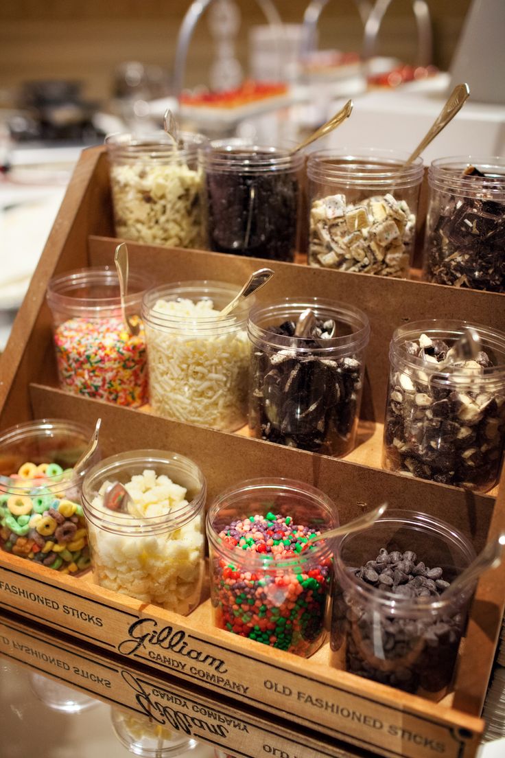 an open box filled with lots of different types of candy and toppings on top of it