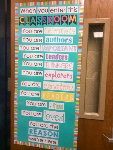 a classroom door decorated with colorful words and writing on the front wall for class room