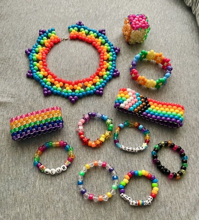 several bracelets and rings are laid out on a bed with the bead together