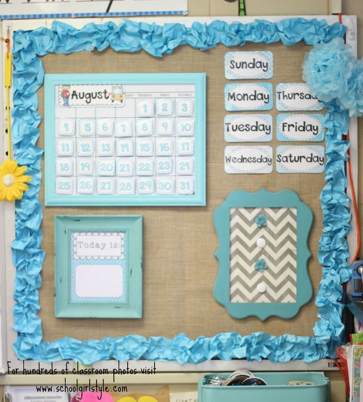 a bulletin board decorated with blue paper flowers