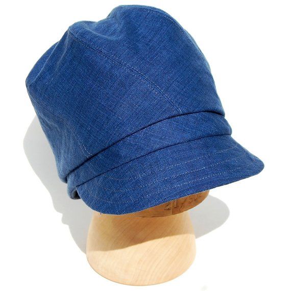 a blue hat sitting on top of a wooden mannequin's dummy head