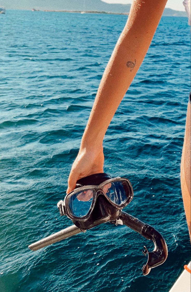 a person wearing goggles and diving gear on a boat