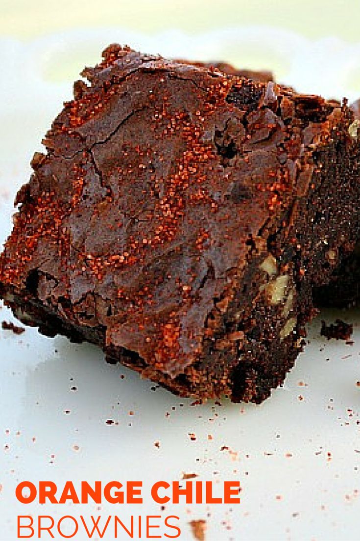 two pieces of brownie sitting on top of a white plate next to each other