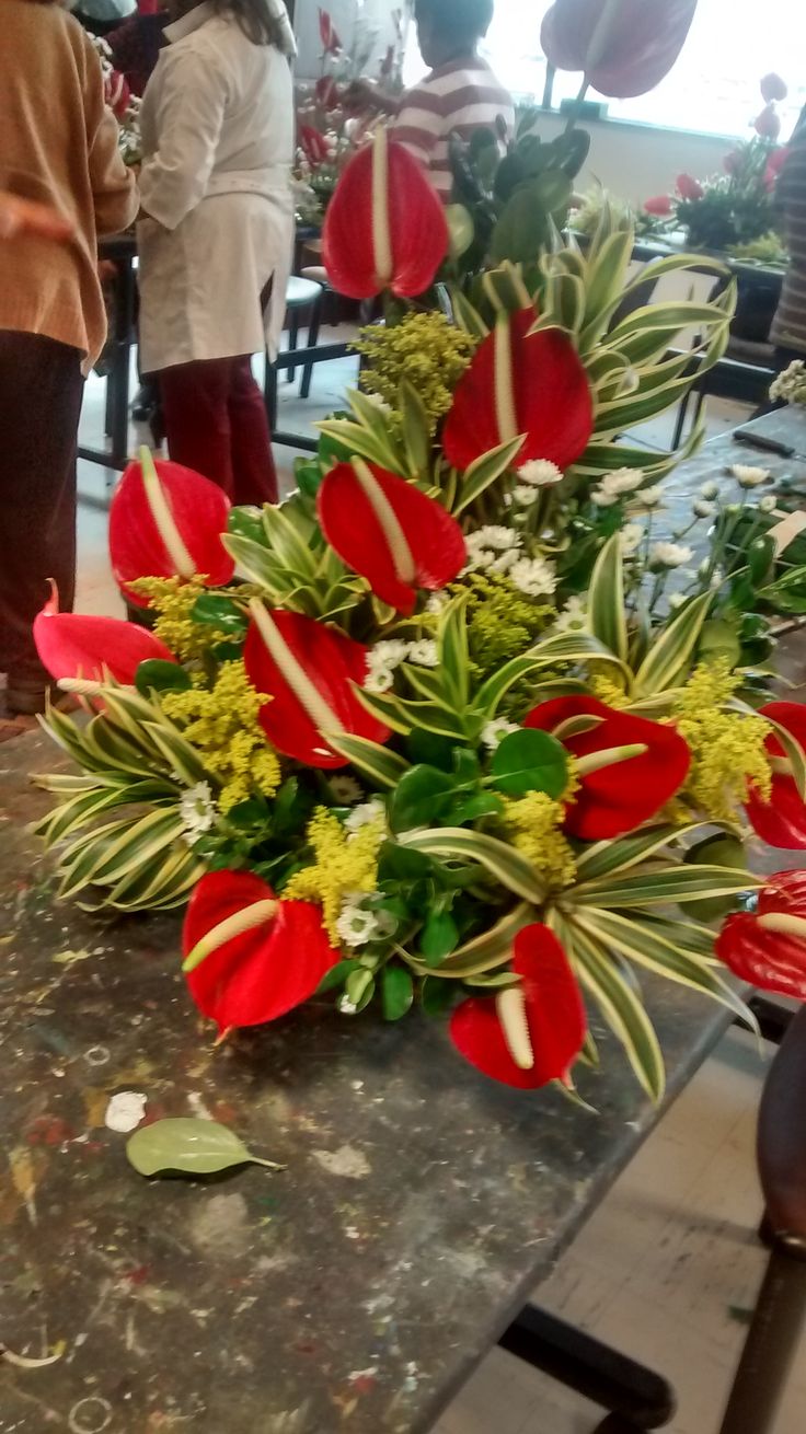 red and white flowers are sitting on a table