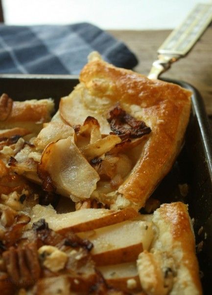 a close up of a piece of food in a pan on a table with a fork