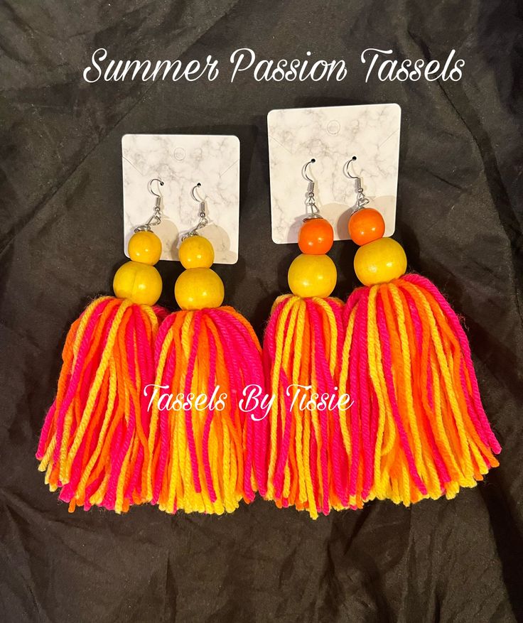 two pairs of tassels with orange, yellow and pink beads on top of each other