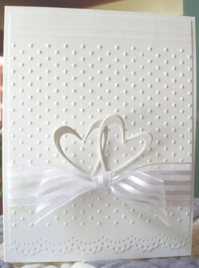 a close up of a card with a heart and ribbon on the front that says love