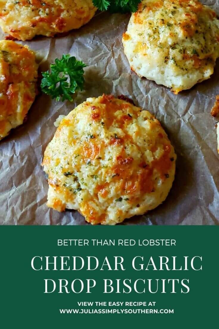 cheddar garlic drop biscuits on wax paper with parsley and parsley sprigs