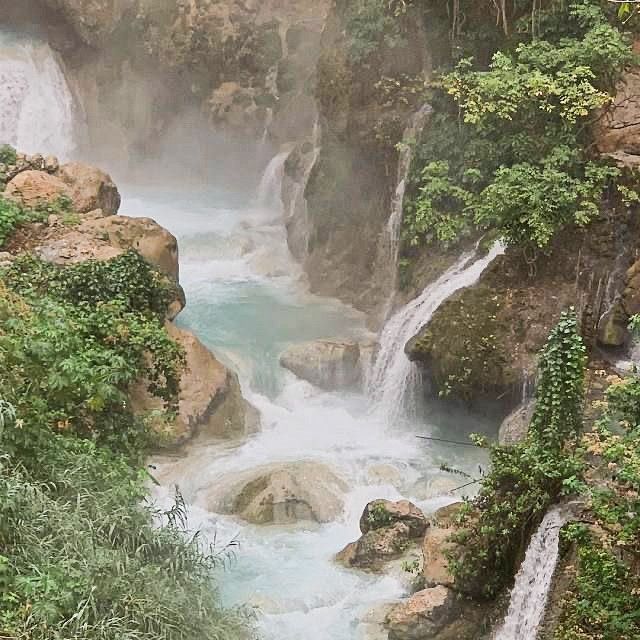 there is a waterfall in the middle of some rocks