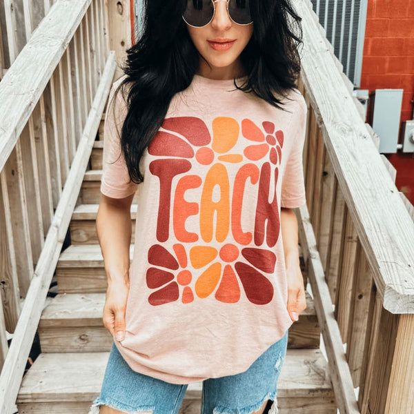 Teach Tee | Shop Mountain Moverz T-Shirts Pink Soft-washed T-shirt For Fall, Peach Letter Print T-shirt For Spring, Peach Graphic Print T-shirt For Spring, Spring Peach T-shirt With Graphic Print, Spring Peach Graphic Print T-shirt, Trendy Spring T-shirt In Soft Fabric, Trendy Heather Peach T-shirt For Summer, Heather Peach Letter Print Top For Spring, Heather Peach T-shirt With Graphic Print For Summer