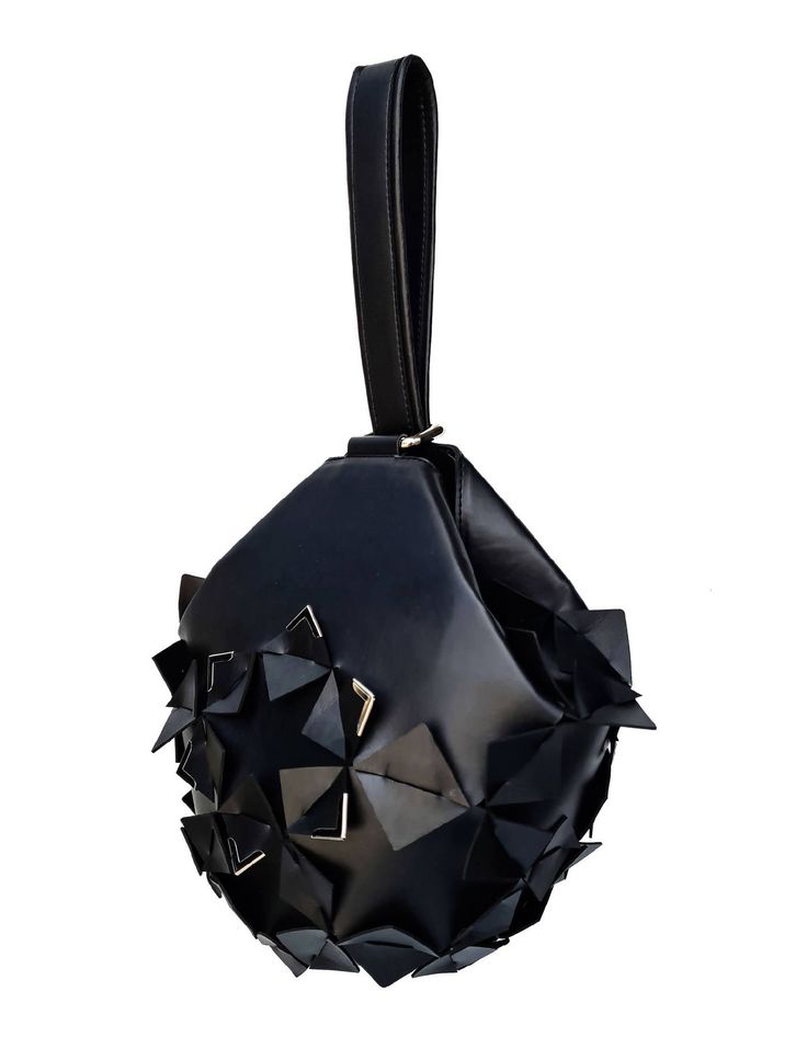 Accessories can make or break an outfit and none speak louder than a bold statement bag. Due to its timeless shape, this bucket bag can be worn effortlessly throughout the year. Carry it on the wrist or hold it for a contemporary take on evening dressing. Our Star Bucket bag is like a precious ornament that will add a luxury and edgy touch to your every look. She's crafted from quality vegan leather to a water-drop silhouette. It's signature three-dimensional geometric surface is punctuated by s Modern Handheld Bucket Bag With Detachable Strap, Modern Handheld Bucket Bag, Modern Handheld Bucket Bag With Detachable Handle, Modern Top Handle Box Bag For Party, Modern Handheld Bucket Bag With Dust Bag, Trendy Evening Bucket Box Bag, Modern Evening Bucket Bag Tote, Modern Evening Bucket Tote Bag, Modern Bucket Bag With Adjustable Strap For Evening