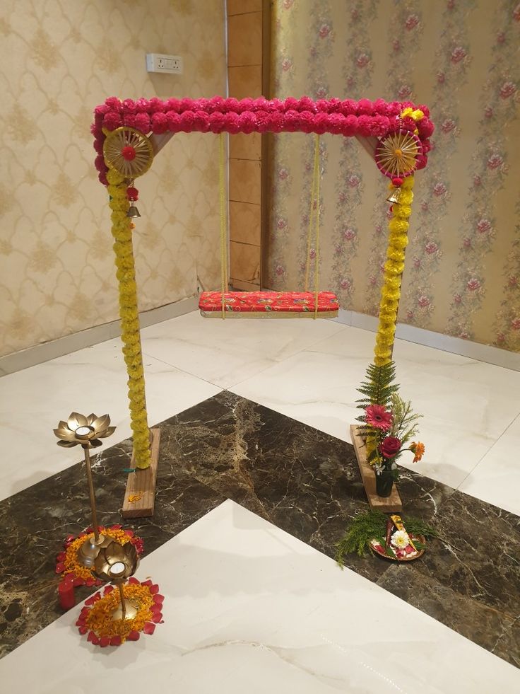 an arrangement of flowers and decorations in a room with marble flooring on the ground