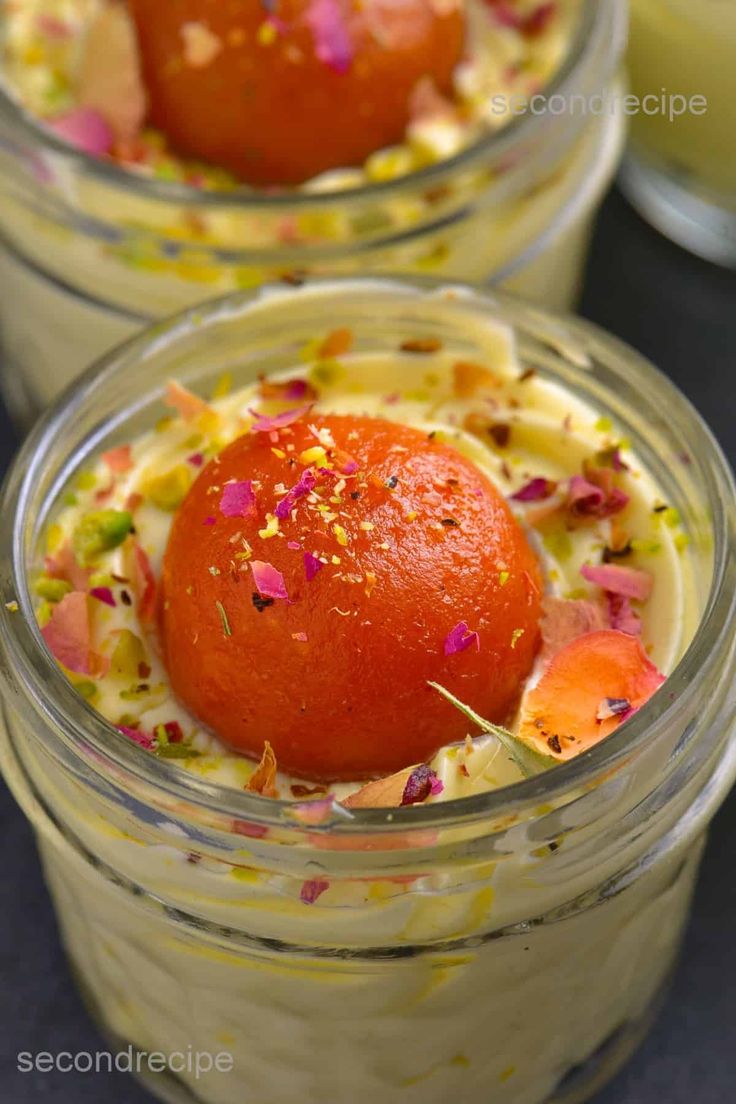 two small jars filled with food on top of a table