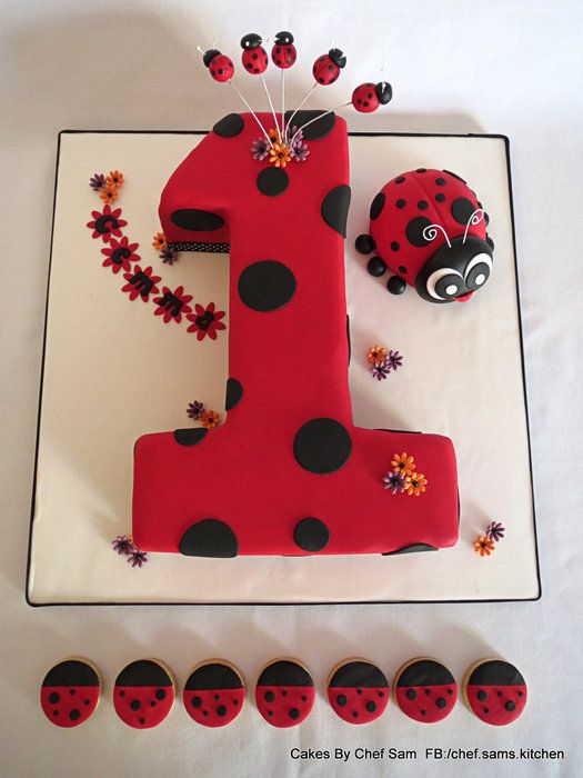 a red and black cake with ladybugs on it