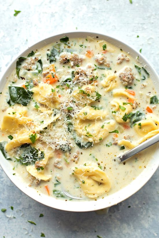 a white bowl filled with pasta and meat soup