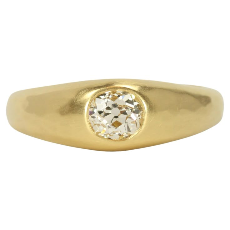 a yellow gold ring with a diamond in the center