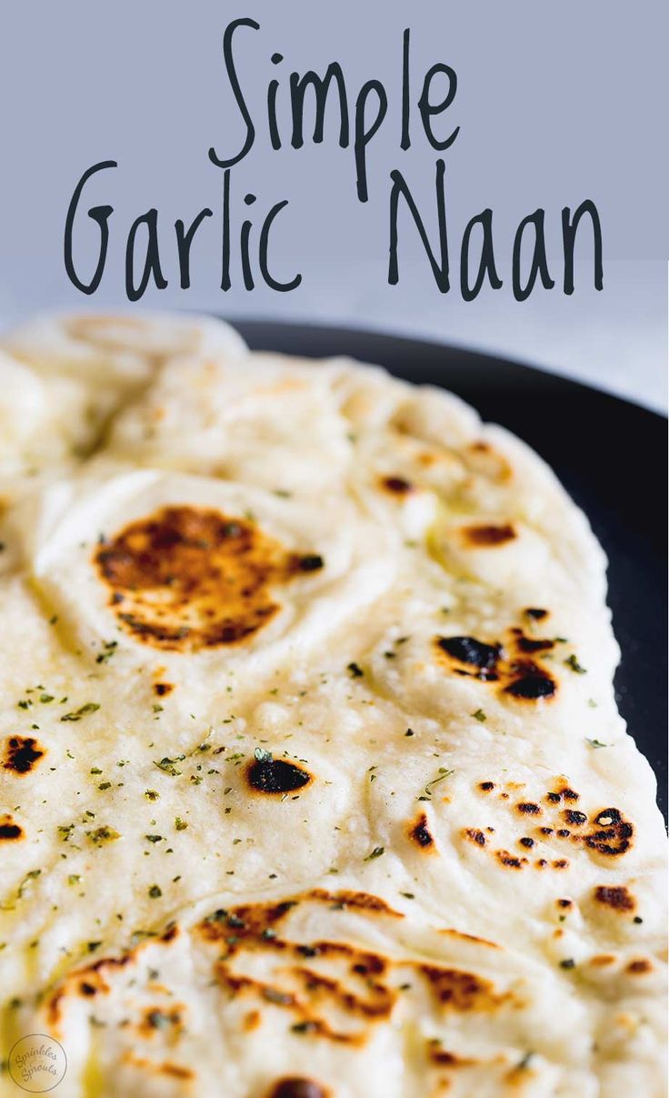 garlic naan on a black plate with text overlay