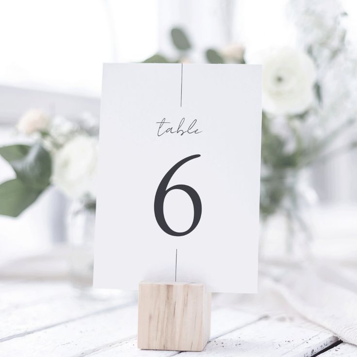 a table number is placed on a wooden block