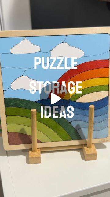 the puzzle storage idea is displayed on top of a white table with wooden pegs