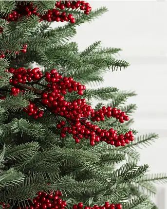 a christmas tree with red berries and green leaves