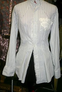 a mannequin wearing a white shirt and black pants