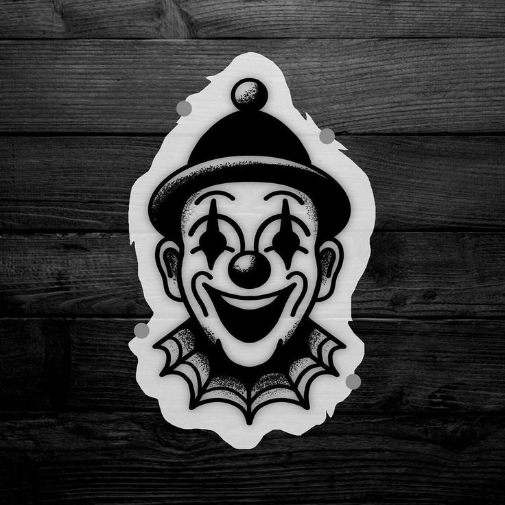 a black and white photo of a clown face on a wooden background with text that reads,