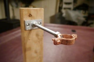 a close up of a metal handle on a wooden door