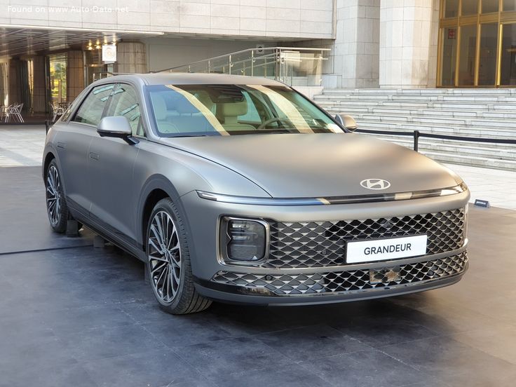 a silver car parked in front of a building