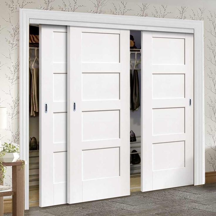 two white doors are open in a room