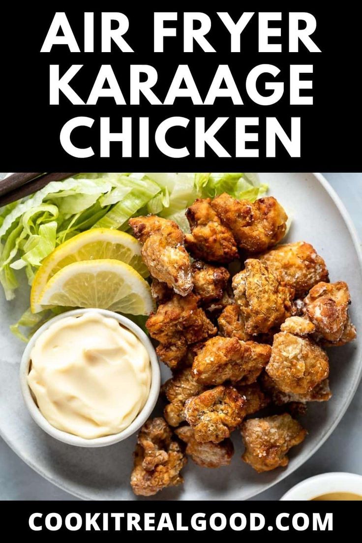 air fryer karaage chicken on a white plate with lettuce and lemon wedges