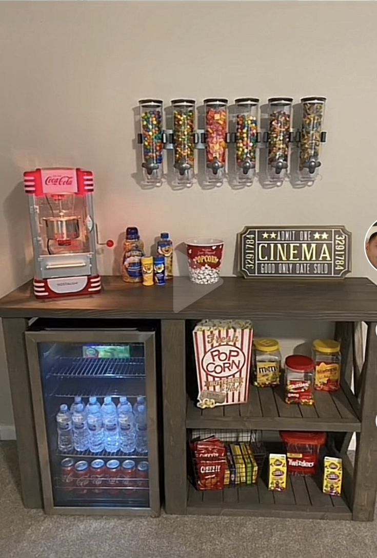 a shelf filled with drinks and snacks on top of a carpeted floor next to a wall