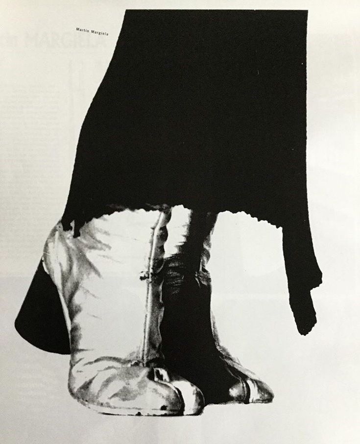 a black and white photo of a person's feet in high heeled shoes