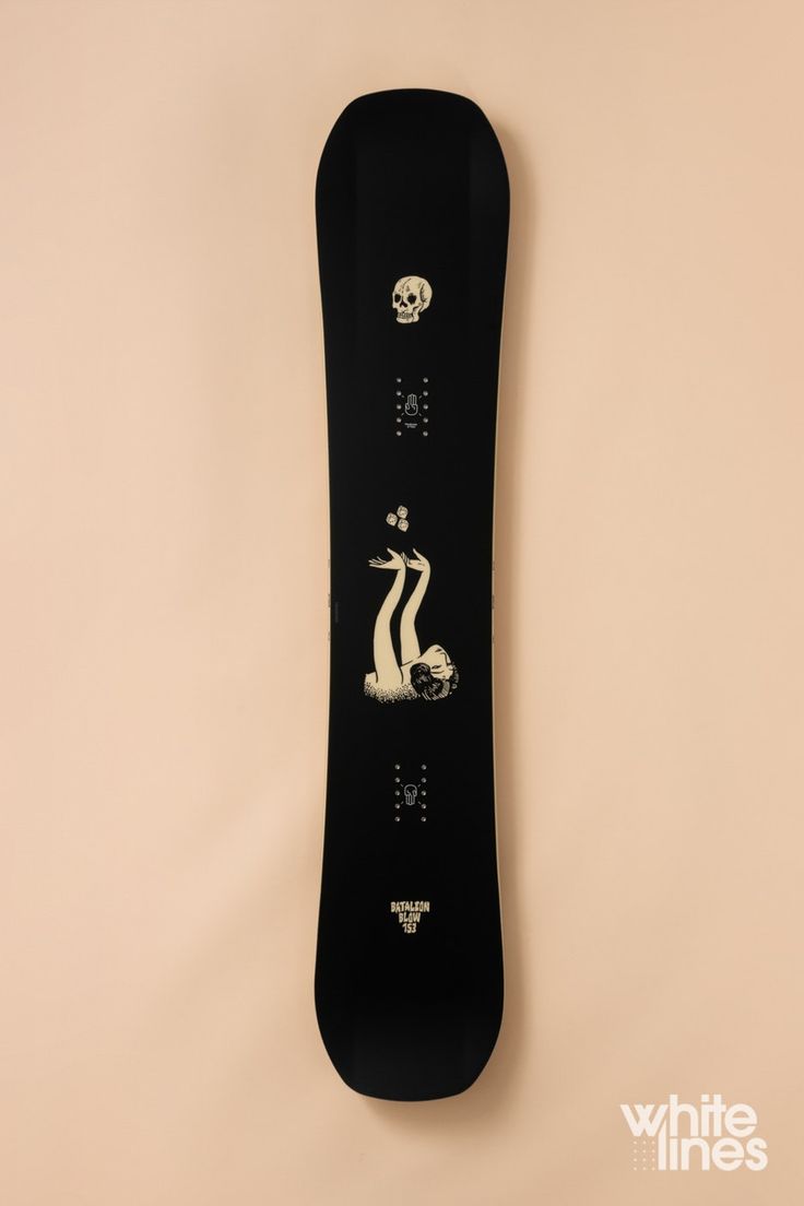 a black snowboard hanging on the wall with an image of a boat and waves