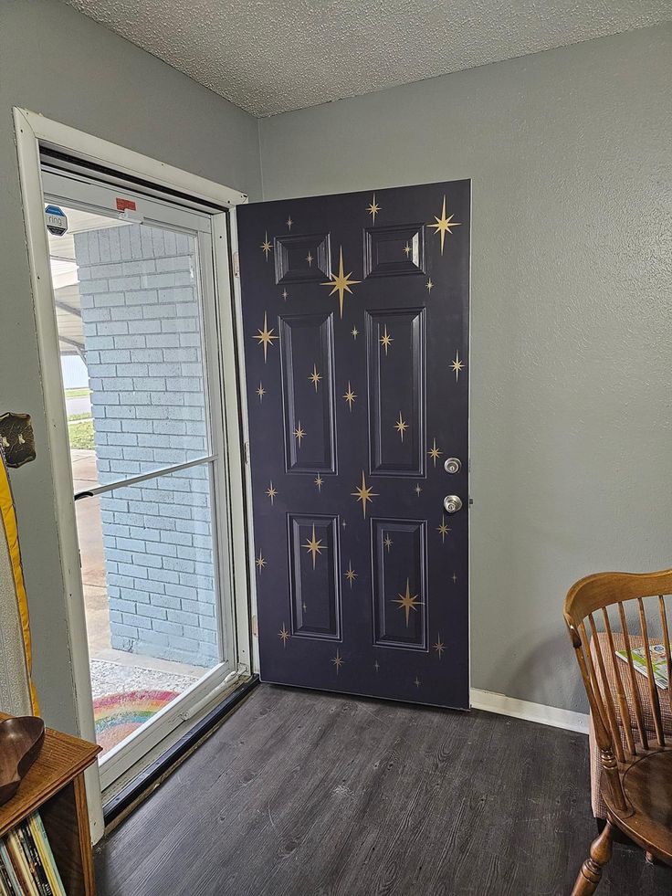 a door with stars painted on it in a room