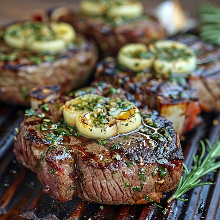 grilled steaks with potatoes and herbs on a grill