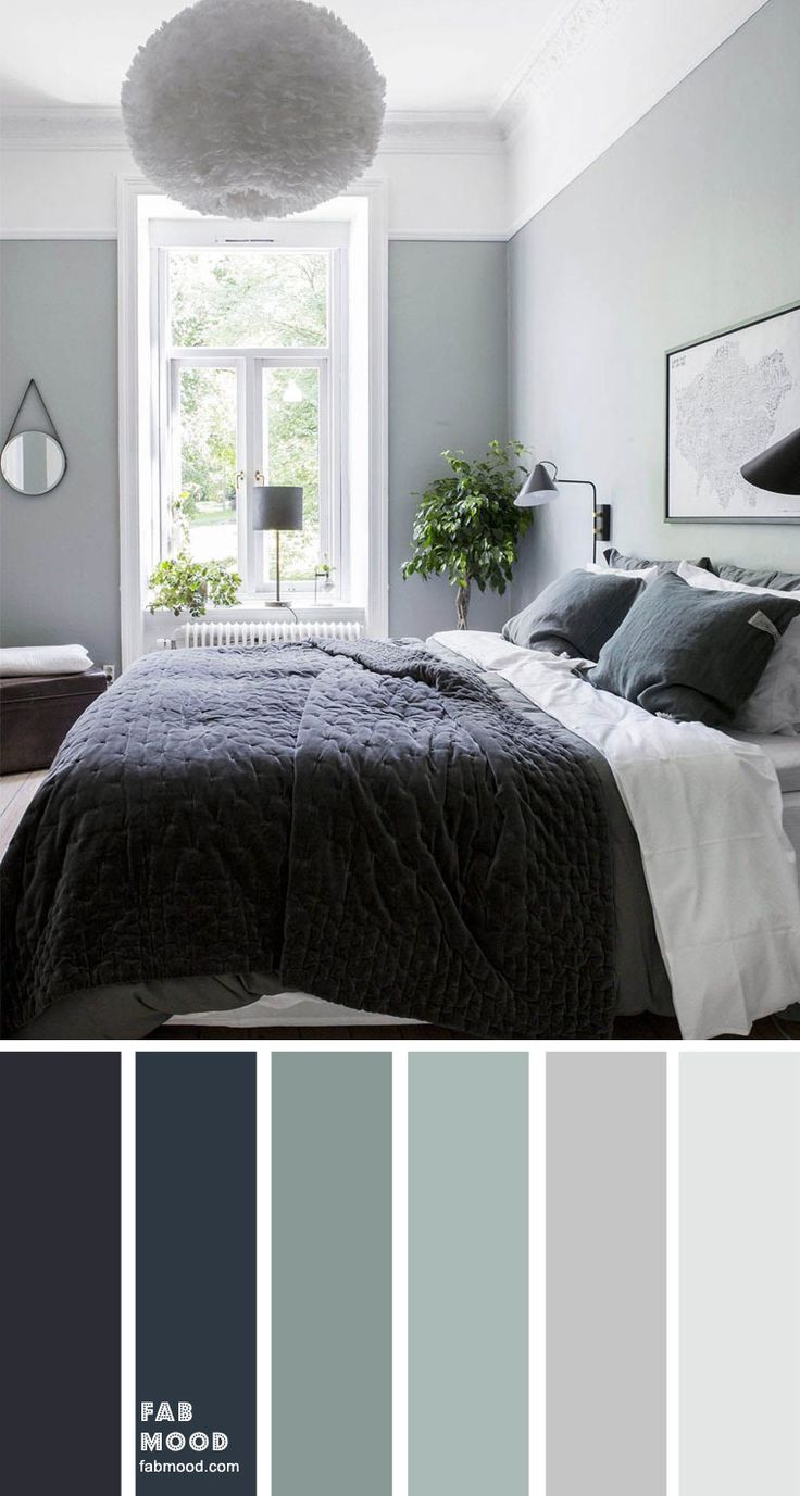 a bedroom with grey walls and white trim, gray bedding, blue pillows, green accents