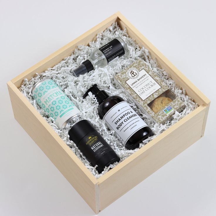 an open wooden box containing several different types of skin care products