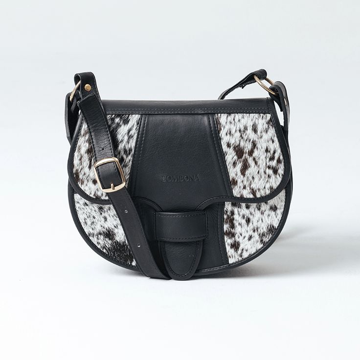 a black and white spotted purse on a white background with a gold buckle in the middle