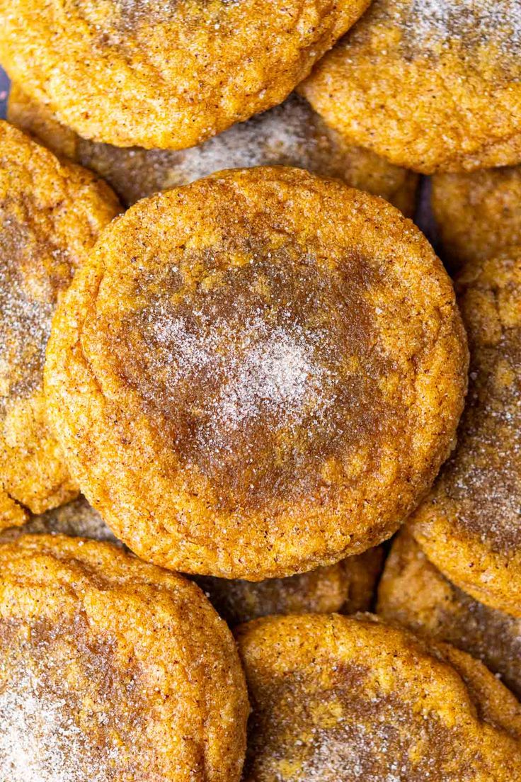 a pile of sugar cookies with powdered sugar on top